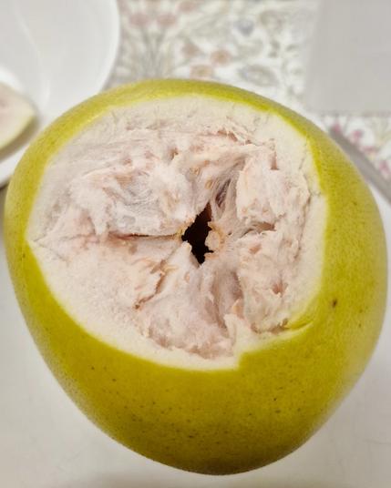 Opened at the top stuff the help of a knife, looks like the pith isn't quite as extensive as some pomelos