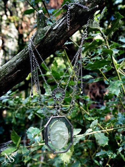 The necklace hangs casually on a branch in the middle of the forest. We can see that there is only one chain to attach behind the neck and that the necklace has a chain extension. The background is green foliage and bark.
❉
Le collier est accroché nonchalamment à une branche au milieu de la forêt. On peut voir qu’il n’y a qu’une chaîne à attacher derrière le cou et que le collier dispose d’une chaîne de rallonge. L’arrière-plan est constitué de feuillage vert et d’écorce.