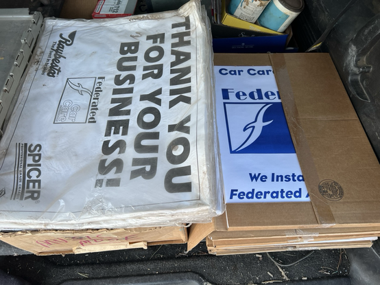 Paper advertising floor mats for in a garage.