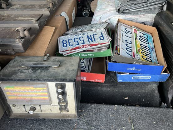 A pile of vintage license plates.