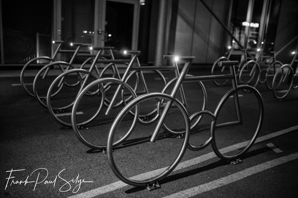 Modern Bike Racks with bicycle lights. Photo is black and white.