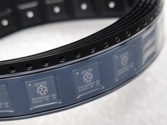 A small coil of cut tape containing RP2350A0A2 IC.