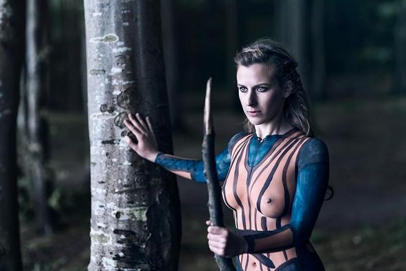 Portrait of a fierce viking woman with her costume painted onto her body
