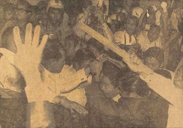 Presidential security agents body shielding Philippine President Ferdinand Marcos as he enters his car, while a rain of placard handles fly all around during protests on January 26, 1970. Photo from the Manila Bulletin. By Manila Bulletin - Original publication: Manila BulletinImmediate source: http://www.gov.ph/edsa/the-ph-protest/, Fair use, https://en.wikipedia.org/w/index.php?curid=52337405