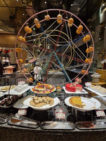 Dessert section of the buffet with a ferris wheel decoration in the background