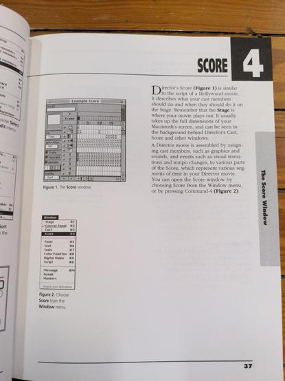 A book open on a wood floor to show page 37, showing the first page of chapter 4, SCORE. A black and white Example Score window and Window menu are pictured to the left and a block of text describing the Score window on the right.