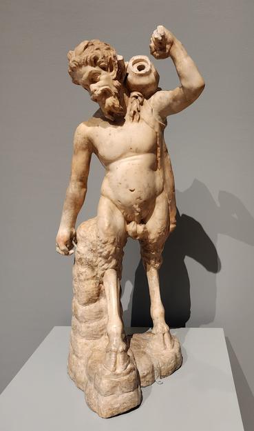 marble statue of Pan with a jug slung over his shoulder