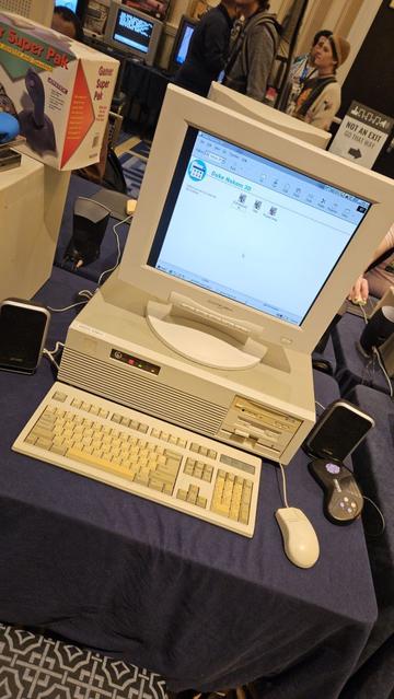 A beige PC running Windows 95 with an Explorer window showing Duke Nukem 3D icons.