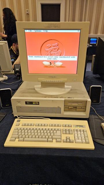 A beige PC running a fortune cookie program that states "Your emotional ties aren't color coordinated with your suits."