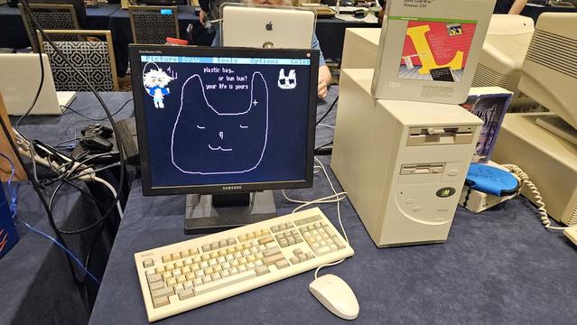A beige PC running a drawing program. On screen is a rabbit drawing asking "plastic bag...or bun bun? your life is yours"