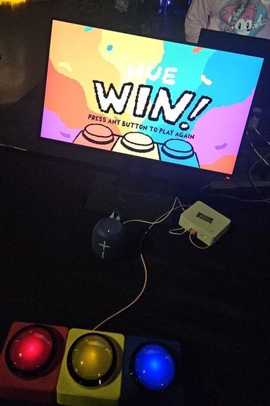 An arcade game called Guess Hue, with three large buttons colored red, yellow, and blue. I was the winner.