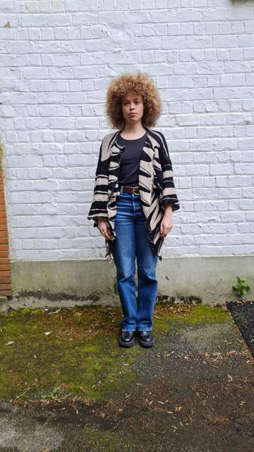 A person wearing a knitted kimonos with doodled horizontal stripes to bypass cctv face recognition.