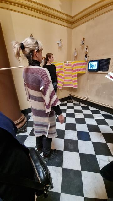 Exhibition view: visitor trying the garment with live CCTV face recognition (#opencv)
