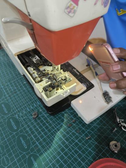 an open sewing machine being cleaned and oiled