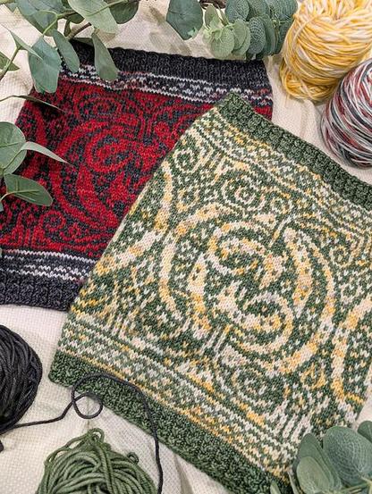 Image shows two versions of the Guardian cowl. The design features pairs on intertwined dragons with top and bottom borders in a Celtic braid style design. The hems of the cowl are cabled. The top cowl is knit in a pale yellow on a background of sage green. The bottom cowl is knit in red on a background of dark grey.
