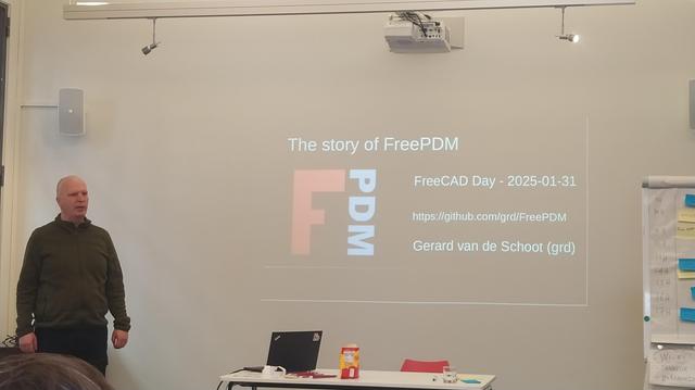 Grd standing beside his welcome slide at FreeCAD day.