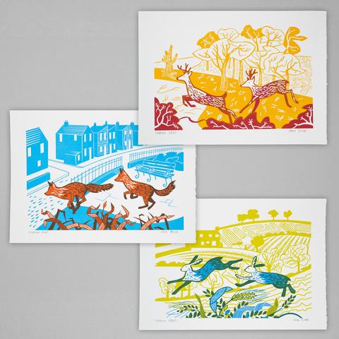 A set of three screenprints, one of leaping stags with trees behind, one of leaping foxes with houses behind and one of leaping hares with fields behind.