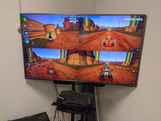 A big TV screen running 4 player supertuxkart