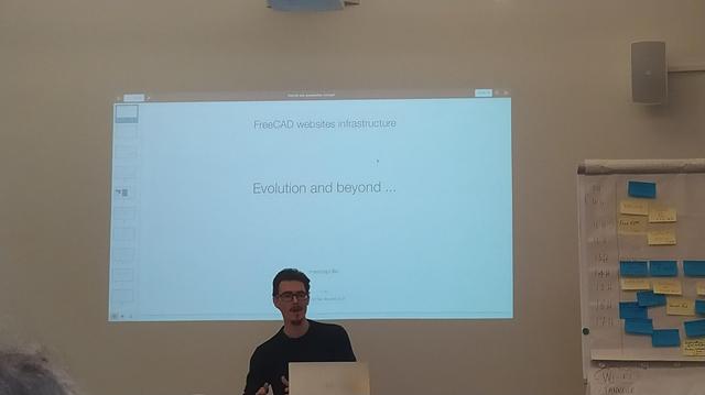 Marcus speaking while seated at FreeCADDay.
