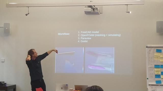 Julian presenting in front of a projector.
