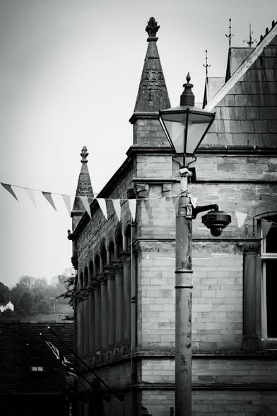 A lamppost, bunting, and an old Victorian building.