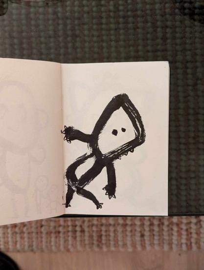 Petit dessin intuitif et enfantin au feutre noir.