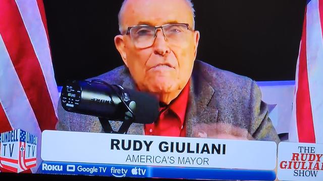 Image of a TV with Rudy Giuliana on it.