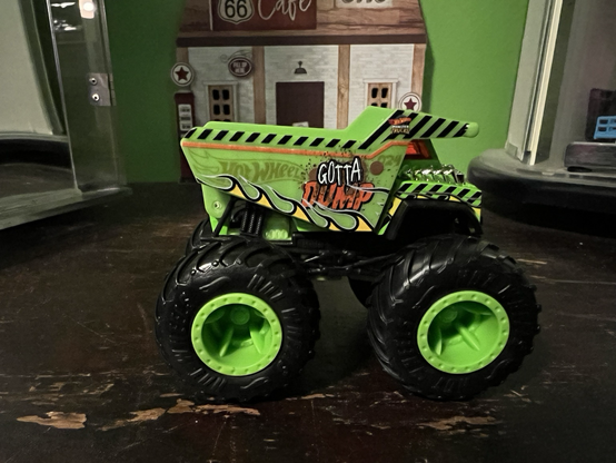 A green monster truck toy called Gotta Dump made by HotWheels.