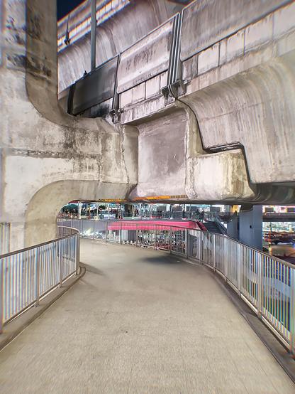 Photograph of an interesting cement structure that's part of a high walk under the BTS sky train.