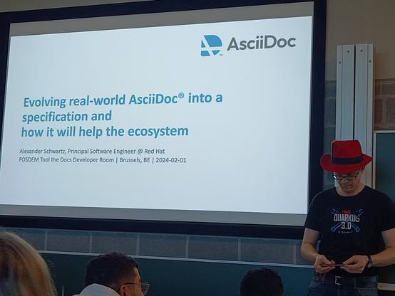 Alexander in front of a slide: Evolving real-world AsciiDoc into a specification and how it will help the ecosystem