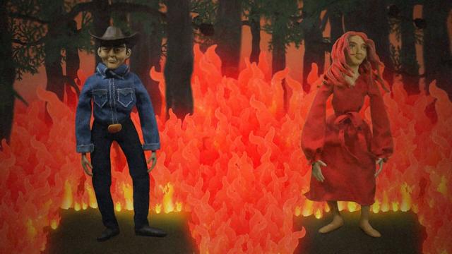 Two claymation puppets stand in a stop-motion wildfire forest