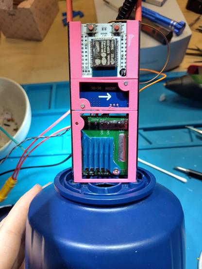 several PCBs mounted in a 3d printed, vertical frame. Standing on top of the camping lamp foot. (front view, clean look)