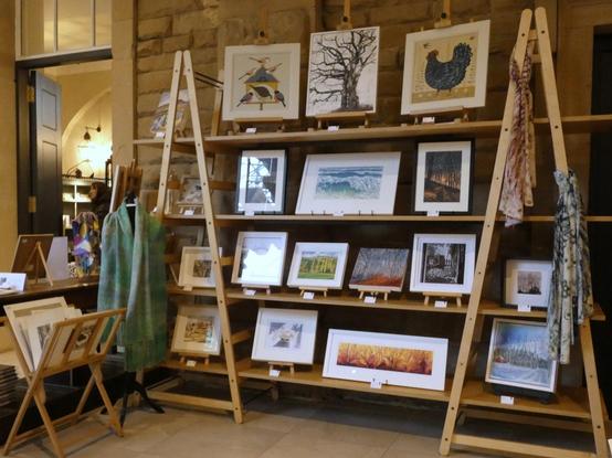 A large A Frame shelving unit diplaying framed artworks