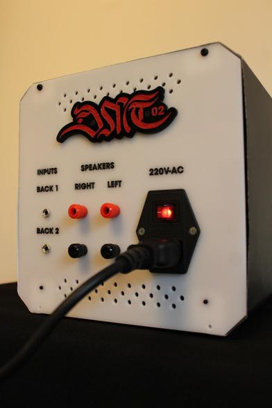 A photograph showcasing the clock described in the previous message, Rear view, with the creator's logo, "220V AC" text, and a C14 power socket featuring a switch.