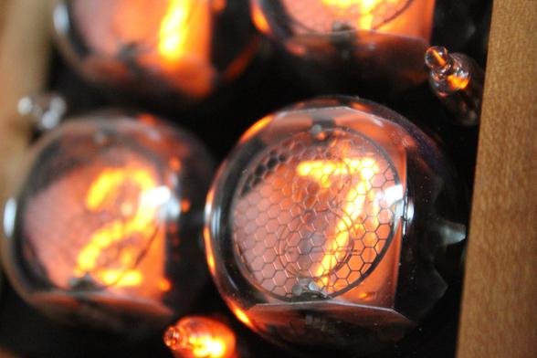 Macro photograph of lit-up nixie tubes, with the one in the foreground displaying the digit 7