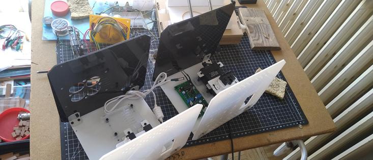 A top view of both boxes, with no cover and the electronics not yet installed inside