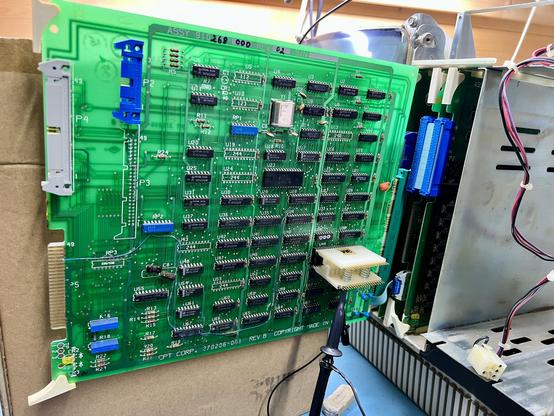 Closeup of the CPT's floppy controller mounted on the riser board. There's a 40 pin test connector on the WD1771 floppy controller with a scope probe hanging off /CS (pin 3) to show that the chip is selected a few times at boot. It's looking hopeful!