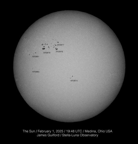 An image of the solar disk showing a group of sunspots at about the 10 o'clock position. First image in monochrome, second image with false color applied.