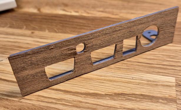 A C64 side bracket covered in veneer. All the ports are cut out, it's a little rough around the edges still.