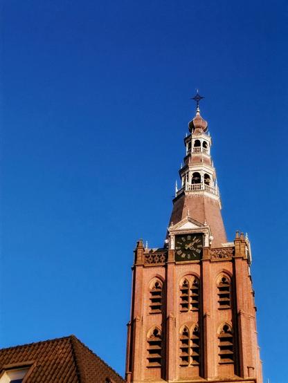 The intricate details of this clock tower against a crisp blue sky—architecture that stands the test of time.
