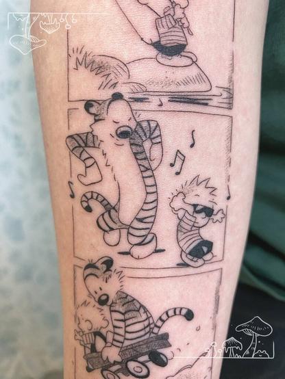 An arm tattoo depicting a panel from Calvin and Hobbes with the characters dancing