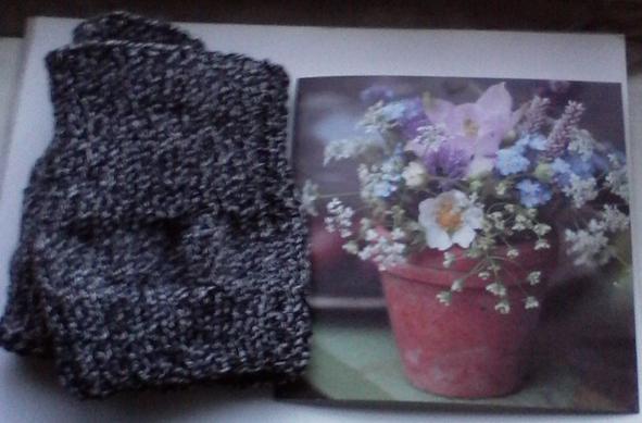 A pair of grey wool Wellie Toppers on the left and on the right the front of a card showing a terracotta pot cotaining various flowers