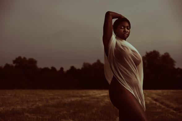 Editorial photograph of a model on an open field