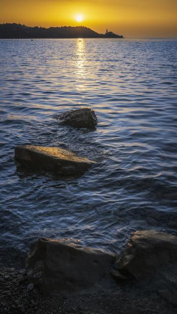 Sunset in Piran Slovenia casting a golden glow over the Adriatic sea. Piran is on a peninsula on the far horizon and rocks in the foreground texture to the scene

https://joan-carroll.pixels.com/featured/piran-slovenia-sunset-joan-carroll.html

#sunset #piran #slovenia #seascape #ocean #sea #seaside #reflection #golden #giftideas #travel #travelphotography @joancarroll