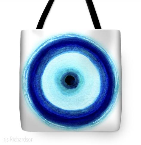 Evil Eye on white bag with black handle. The symbolism of the Evil Eye: I did not know much about Evil Eye protection until I lived in Italy. I had seen the good luck charm but had not known its history. After someone recommended that I get one, I looked closer into the beliefs and history behind it. After over two years in this pandemic, I started to create good luck charm drawings. They pop up all around us just before we cross over to the new year. I love what another artist wrote, she creates them to promote good karma and to encourage people to live their most meaningful lives. How beautiful is that?!  “Belief in the evil eye is ancient and ubiquitous; it occurred in ancient Greece and Rome, in Jewish, Islamic, Buddhist, and Hindu traditions, and in indigenous, peasant, and other folk societies, and it has persisted throughout the world into modern times.” Britannica