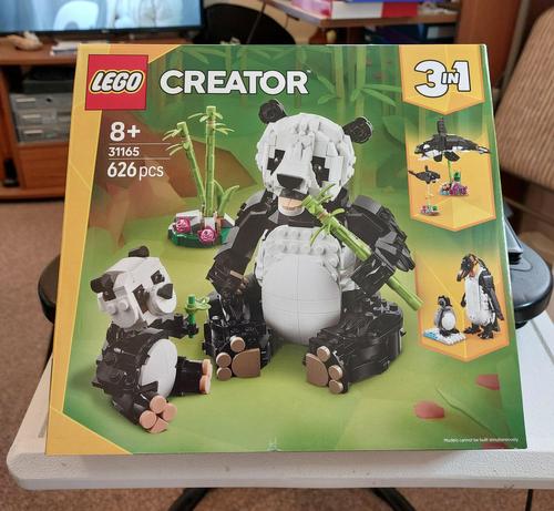 A box of Lego Creator 3in1, propped up on my table, one that let's me build an adult and baby panda/penguin/orca