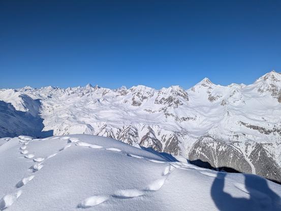 View of snowy peaks of the main ridge of the Alps.