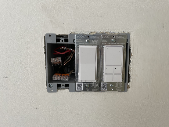 2 smart switches installed in a 3 gang wall box, with wire terminations visible in the 3rd gang