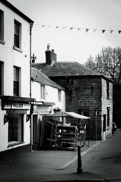 View along the street with a grocer's stall.