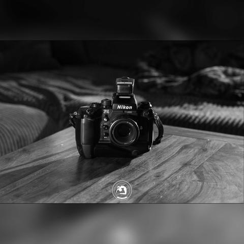 black and white photo of the Nikon F4 with attached AF NIKKOR 50mm f/1.8D and MB-21 battery grip, making it a Nikon F4S.